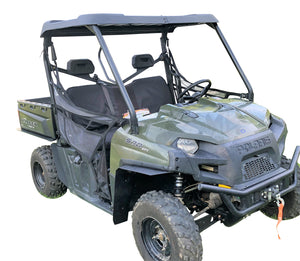 A Polaris Ranger UTV equipped with full size fender flares to cover the tire tread and enhance mud protection.